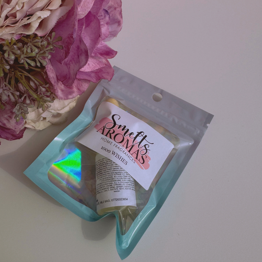 1000 Wishes Fragrance Oil Mist Diffuser Oil from Smelts Aromas with a flower in the background