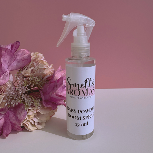 Baby Powder room spray bottle from Smelts Aromas with flowers on a pink background