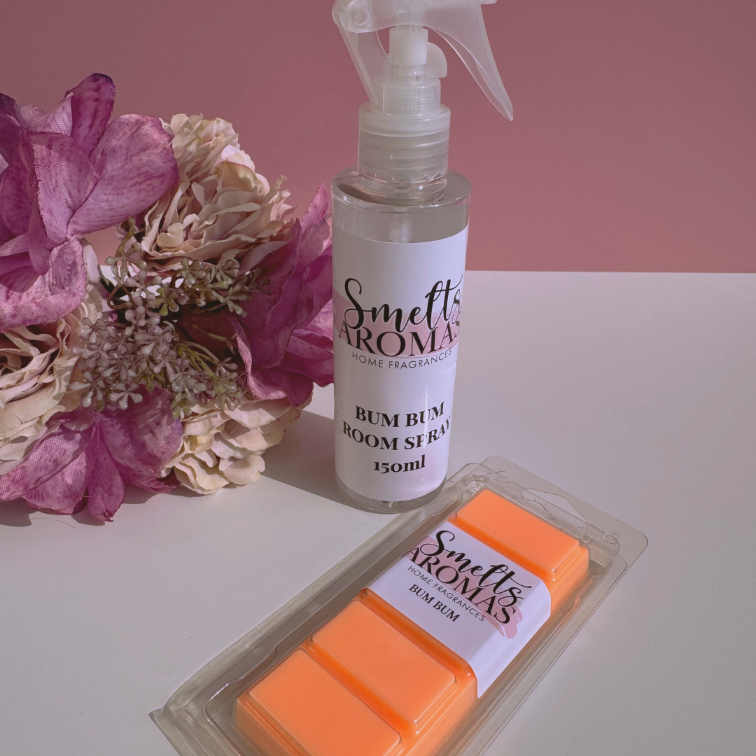 Smelts Aromas Bum Bum room spray and wax melts bundle deal with a flower in the background with a pink background