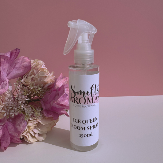 Ice Queen room spray bottle from Smelts Aromas with flowers on a pink background