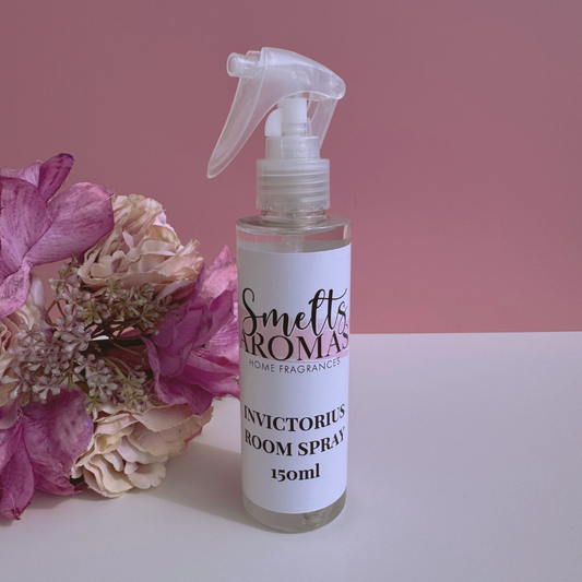 Invictorius room spray bottle from Smelts Aromas with flowers on a pink background