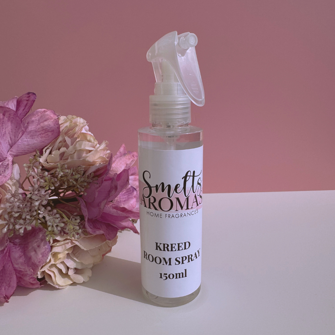 Kreed room spray bottle from Smelts Aromas with flowers on a pink background