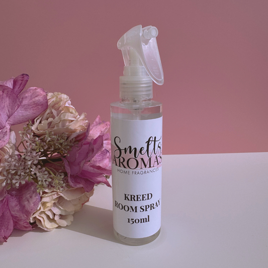 Kreed room spray bottle from Smelts Aromas with flowers on a pink background