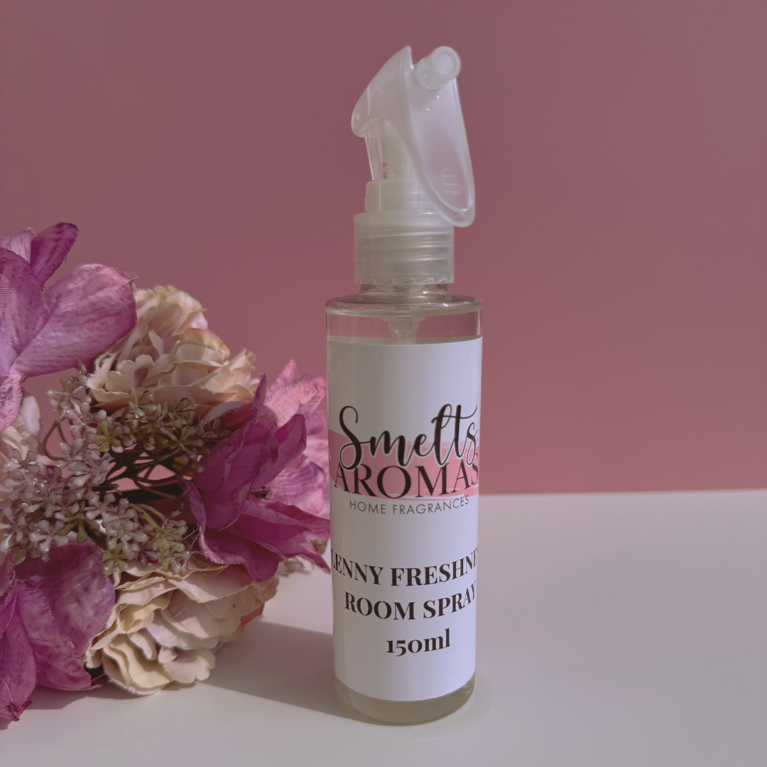 Lenny Freshness room spray bottle from Smelts Aromas with flowers on a pink background