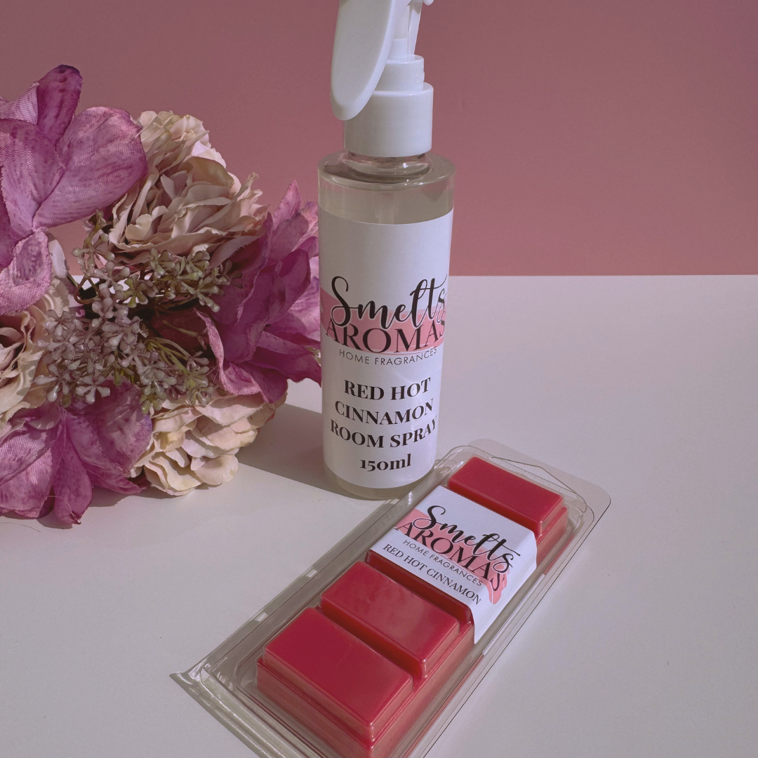 Smelts Aromas Red Hot Cinnamon room spray and wax melts bundle deal with a flower in the background with a pink background