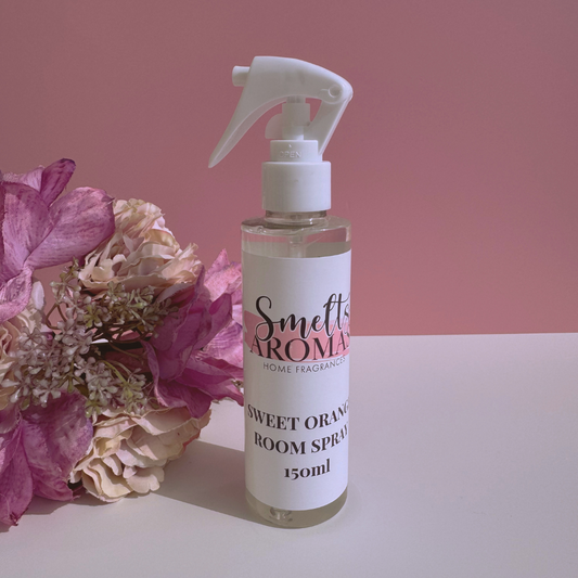 Smetto Aroma sweet orange room spray bottle with flowers on a pink background
