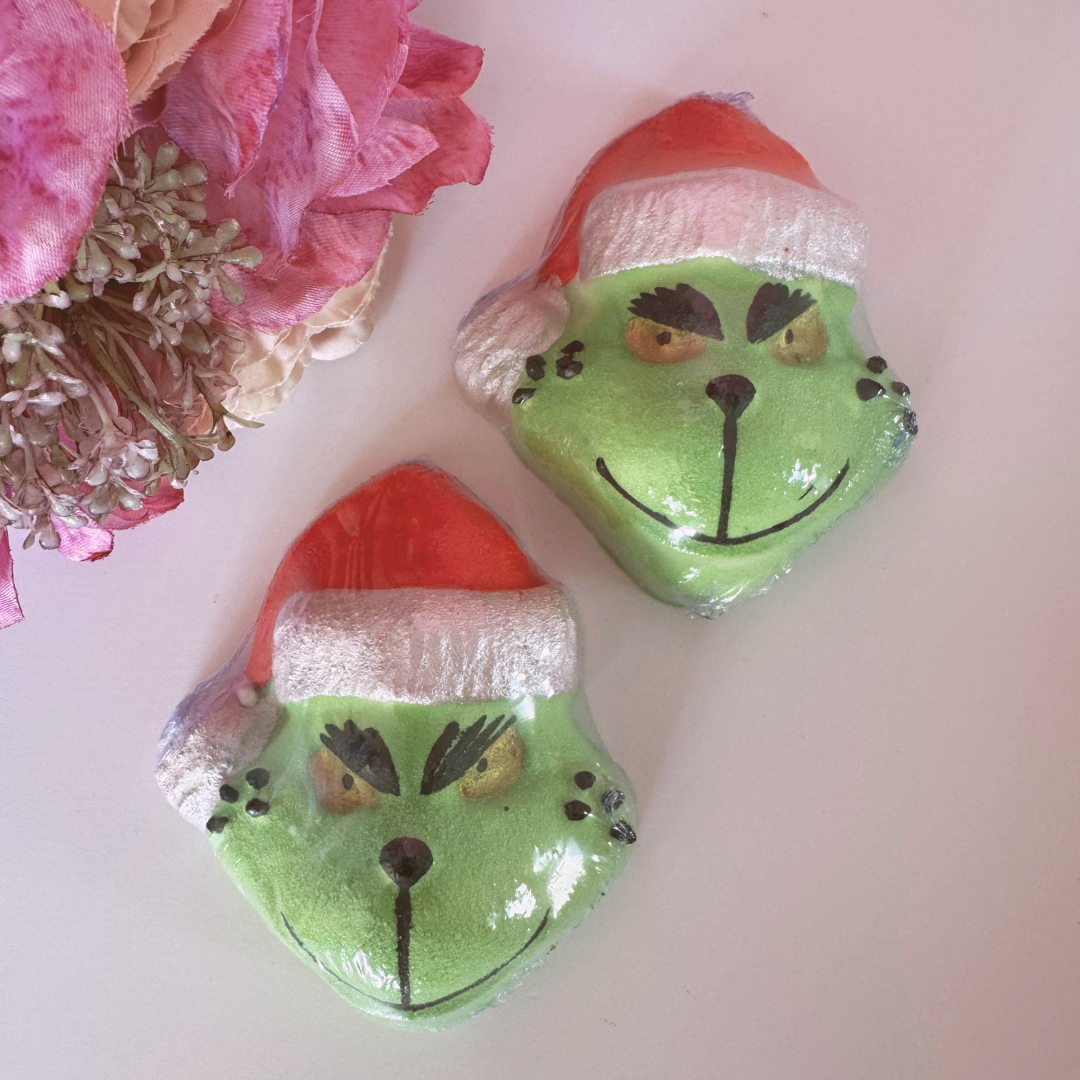 The Grinch Bath Bomb by Smelts Aromas – green handmade Christmas bath bomb with a Grinch face design, fun and festive gift for bath lovers.